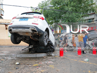 Cars blown over after Super Typhoon Doksuri torrential rain in a community in Jinan, East China's Shandong Province, July 29, 2023. (