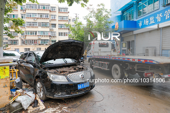 Cars blown over after Super Typhoon Doksuri torrential rain in a community in Jinan, East China's Shandong Province, July 29, 2023. 