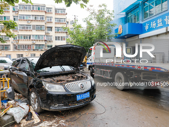 Cars blown over after Super Typhoon Doksuri torrential rain in a community in Jinan, East China's Shandong Province, July 29, 2023. (