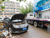 Cars blown over after Super Typhoon Doksuri torrential rain in a community in Jinan, East China's Shandong Province, July 29, 2023. (