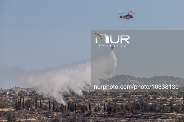 A helicopter of the Jordanian Fire Department throws water over the burnt area, Alassa, Cyprus, on Aug. 5, 2023. Jordan helps with two helic...