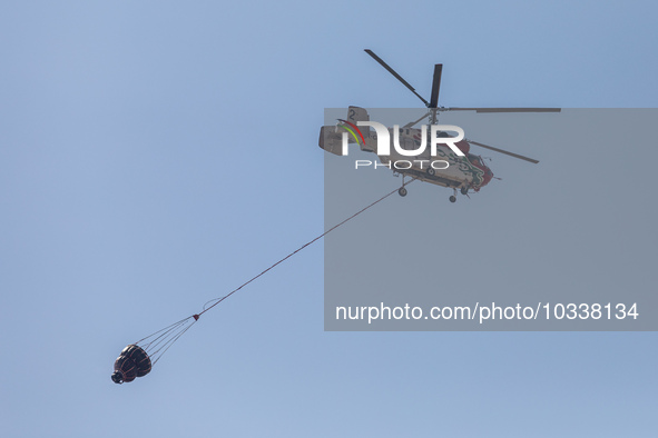 A helicopter of the Jordanian Fire Department is seen over the burnt area, Alassa, Cyprus, on Aug. 5, 2023. Jordan helps with two helicopter...