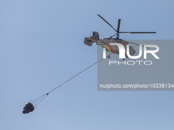 A helicopter of the Jordanian Fire Department is seen over the burnt area, Alassa, Cyprus, on Aug. 5, 2023. Jordan helps with two helicopter...