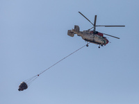 A helicopter of the Jordanian Fire Department is seen over the burnt area, Alassa, Cyprus, on Aug. 5, 2023. Jordan helps with two helicopter...