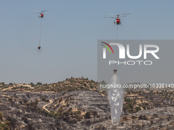 Helicopters of the Jordanian Fire Department throws water over the burnt area, Alassa, Cyprus, on Aug. 5, 2023. Jordan helps with two helico...