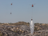 Helicopters of the Jordanian Fire Department throws water over the burnt area, Alassa, Cyprus, on Aug. 5, 2023. Jordan helps with two helico...