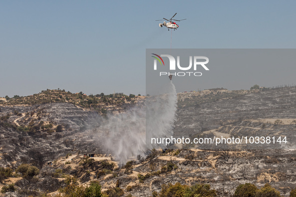 A helicopter of the Jordanian Fire Department throws water over the burnt area, Alassa, Cyprus, on Aug. 5, 2023. Jordan helps with two helic...