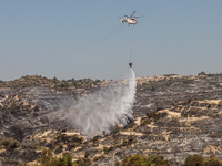 A helicopter of the Jordanian Fire Department throws water over the burnt area, Alassa, Cyprus, on Aug. 5, 2023. Jordan helps with two helic...