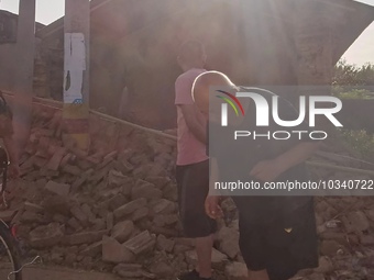 DEZHOU, CHINA - AUGUST 6, 2023 - Citizens watch as the wall of a house collapses after an earthquake in Pingyuan County, Dezhou, Shandong pr...