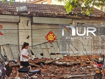 DEZHOU, CHINA - AUGUST 6, 2023 - A citizen passes a collapsed house after an earthquake in an urban area of Pingyuan County, in Dezhou, Shan...