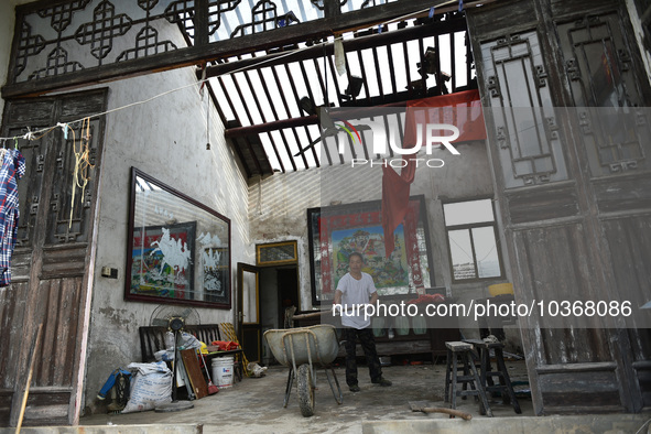 A citizen cleans up a damaged house after a tornado in Dafeng district, Yancheng city, Jiangsu province, China, August 14, 2023. It is under...