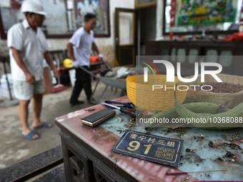 A citizen cleans up a damaged house after a tornado in Dafeng district, Yancheng city, Jiangsu province, China, August 14, 2023. It is under...