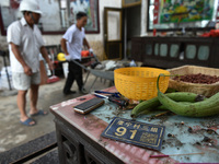 A citizen cleans up a damaged house after a tornado in Dafeng district, Yancheng city, Jiangsu province, China, August 14, 2023. It is under...