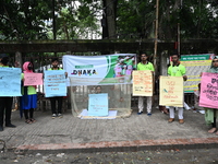 Activist of a social organization hold placards during an awareness campaign against mosquito-borne diseases, in Dhaka, Bangladesh, on Augus...