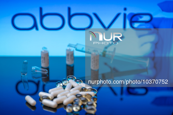 Abbvie Pharma logo seen on screen in the background with pills and medical vial with syringe, seen in this photo illustration, on 14 August...