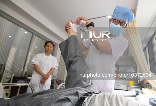 GUIYANG, CHINA - AUGUST 15, 2023 - Zhang Aihua, deputy chief physician of the People's Hospital, conducts a clinical examination for a patie...