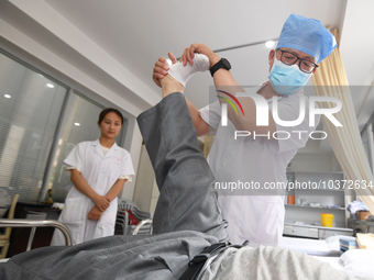 GUIYANG, CHINA - AUGUST 15, 2023 - Zhang Aihua, deputy chief physician of the People's Hospital, conducts a clinical examination for a patie...