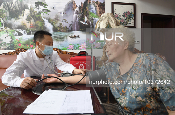 GUIYANG, CHINA - AUGUST 15, 2023 - Doctor Nie Mingzheng measures people's blood pressure in Guiyang, Guizhou province, China, Aug 15, 2023....