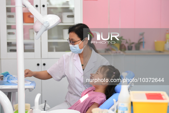 GUIYANG, CHINA - AUGUST 15, 2023 - Pediatric dentist Fang Yiping checks a child for dental caries in Guiyang, Guizhou province, China, Aug....