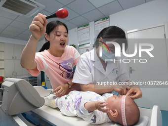 GUIYANG, CHINA - AUGUST 15, 2023 - Pediatrician Su Juan gives a baby a child health checkup in Guiyang, Guizhou province, China, August 15,...