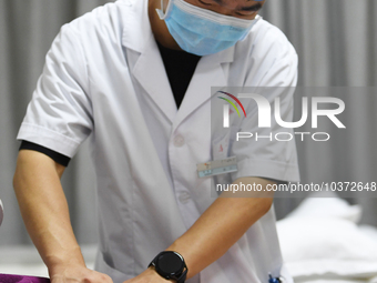 GUIYANG, CHINA - AUGUST 15, 2023 - Zeng Ting, an acupuncturist at the People's Hospital, performs acupuncture treatment on a patient in Guiy...