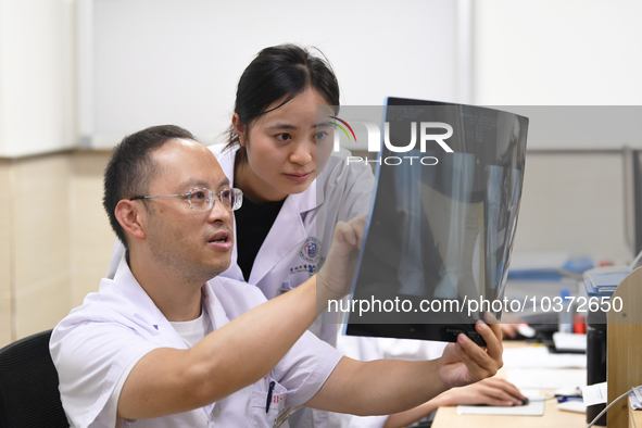 GUIYANG, CHINA - AUGUST 15, 2023 - Wang Lei (L), director of the Department of Bone Surgery at the People's Hospital, works on a clinical di...