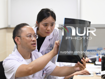 GUIYANG, CHINA - AUGUST 15, 2023 - Wang Lei (L), director of the Department of Bone Surgery at the People's Hospital, works on a clinical di...