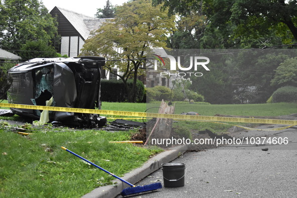 Vehicle strikes a pole and overturns on a driveway of a home in Glen Rock, New Jersey, United States on August 15, 2023. A vehicle struck a...