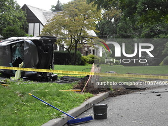 Vehicle strikes a pole and overturns on a driveway of a home in Glen Rock, New Jersey, United States on August 15, 2023. A vehicle struck a...