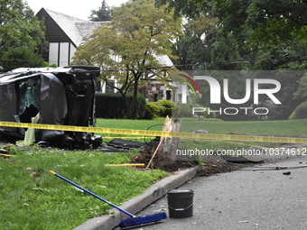 Vehicle strikes a pole and overturns on a driveway of a home in Glen Rock, New Jersey, United States on August 15, 2023. A vehicle struck a...