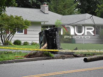 Vehicle strikes a pole and overturns on a driveway of a home in Glen Rock, New Jersey, United States on August 15, 2023. A vehicle struck a...