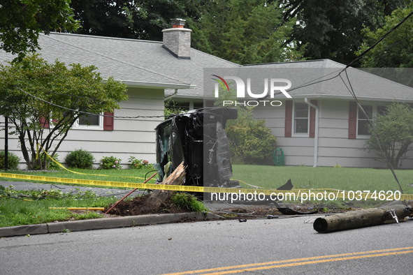 Vehicle strikes a pole and overturns on a driveway of a home in Glen Rock, New Jersey, United States on August 15, 2023.  One person was sev...