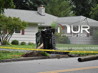 Vehicle strikes a pole and overturns on a driveway of a home in Glen Rock, New Jersey, United States on August 15, 2023.  One person was sev...