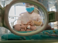 TENGZHOU, CHINA - AUGUST 17, 2023 - A neonatal nurse cares for a newborn in Tengzhou city, Shandong province, China, August 17, 2023. August...