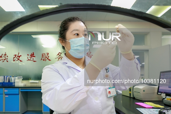 TENGZHOU, CHINA - AUGUST 17, 2023 - A nurse checks a blood sample at a laboratory in Tengzhou city, Shandong province, China, August 17, 202...