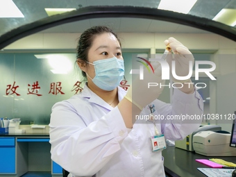 TENGZHOU, CHINA - AUGUST 17, 2023 - A nurse checks a blood sample at a laboratory in Tengzhou city, Shandong province, China, August 17, 202...