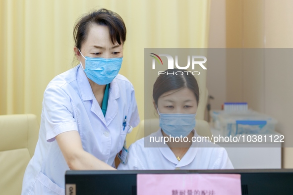 TENGZHOU, CHINA - AUGUST 17, 2023 - Geng Xingling, chief obstetrician, instructs a doctor to prescribe medicine in Tengzhou city, Shandong p...