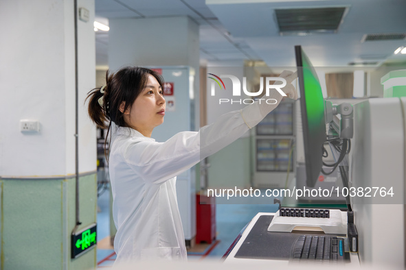 Laboratory doctor Li Qiujin conducts specimen testing in Chongqing, China, August 18, 2023. August 19 is the Chinese Doctor's Day. 