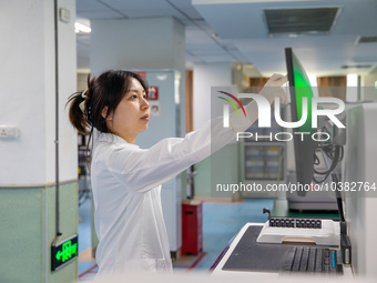 Laboratory doctor Li Qiujin conducts specimen testing in Chongqing, China, August 18, 2023. August 19 is the Chinese Doctor's Day. (