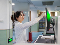 Laboratory doctor Li Qiujin conducts specimen testing in Chongqing, China, August 18, 2023. August 19 is the Chinese Doctor's Day. (