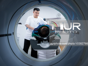 Radiologist Cheng Lu assists a patient with a CT examination in Chongqing, China, August 18, 2023. August 19 is the Chinese Doctor's Day. (