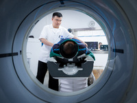 Radiologist Cheng Lu assists a patient with a CT examination in Chongqing, China, August 18, 2023. August 19 is the Chinese Doctor's Day. (