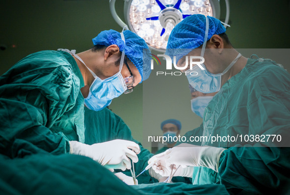 Gastrointestinal surgeons Pang Yong and Li Haitao operate on a patient in Chongqing, China, August 18, 2023. August 19th is the Chinese Doct...