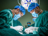 Gastrointestinal surgeons Pang Yong and Li Haitao operate on a patient in Chongqing, China, August 18, 2023. August 19th is the Chinese Doct...