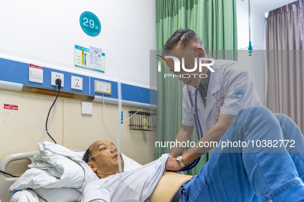 Gastroenterologist Tian Chuanzai examines a patient in Chongqing, China, August 18, 2023. August 19th is the Chinese Doctor's Day. 