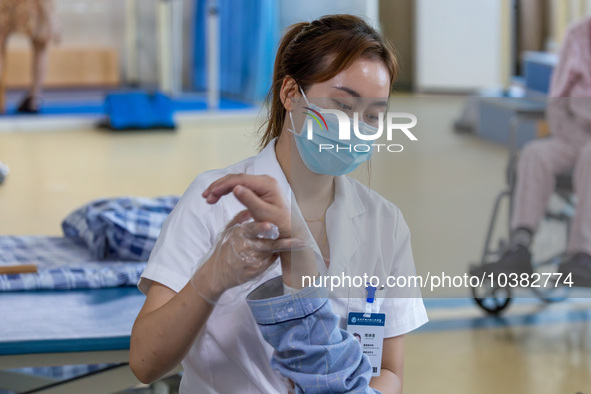 Rehabilitation doctor Zhou Shijie works on a patient in Chongqing, China, August 18, 2023. August 19 is the Chinese Doctor's Day. 