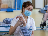 Rehabilitation doctor Zhou Shijie works on a patient in Chongqing, China, August 18, 2023. August 19 is the Chinese Doctor's Day. (