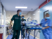 Emergency department doctor Luo Pengyu (left) escorts an emergency patient into the emergency room in Chongqing, China, August 18, 2023. Aug...