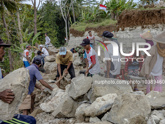 Villagers, including men and women, work together (gotong royong) to renovate a broken village road at Kebumen, Central Java, Indonesia on A...