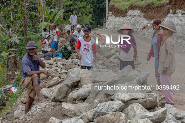 Villagers, including men and women, work together (gotong royong) to renovate a broken village road at Kebumen, Central Java, Indonesia on A...